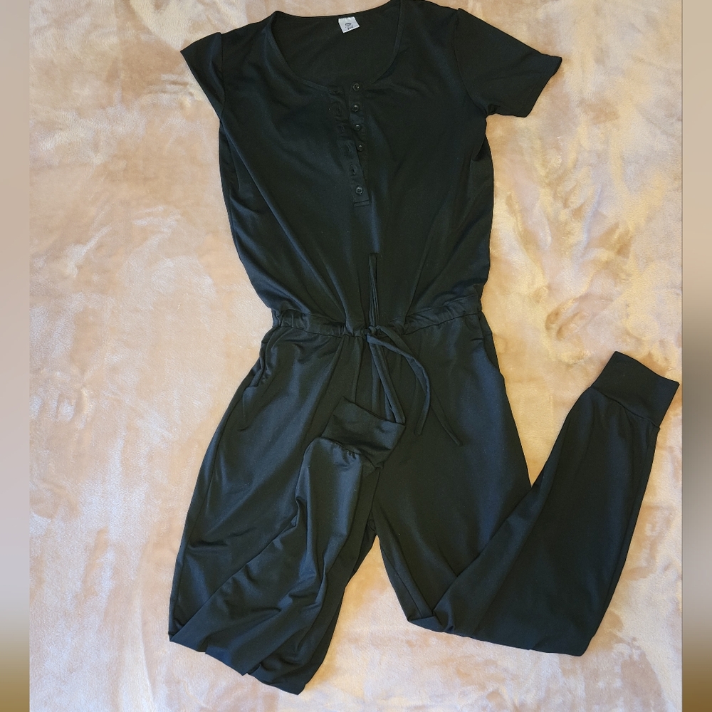 One piece women's Senita black jumpsuit. Short sleeves, size M, jogger cuffs